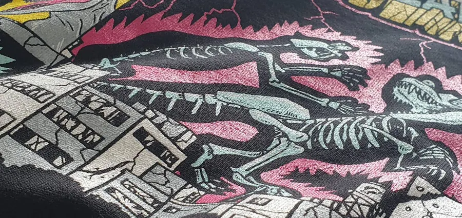 Multi-colour screen-printed illustration on a black tee, close up